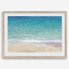 This fine art aerial beach print showcases the mesmerizing colors of the ocean in vivid detail. From the deep blue depths to the vibrant greenish turquoise blue, transitioning to the golden sandy beach and the crashing white surf.