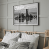 Black and white photo of weathered pilings on an Alaskan beach with snow-capped mountains in the background – fine art print.