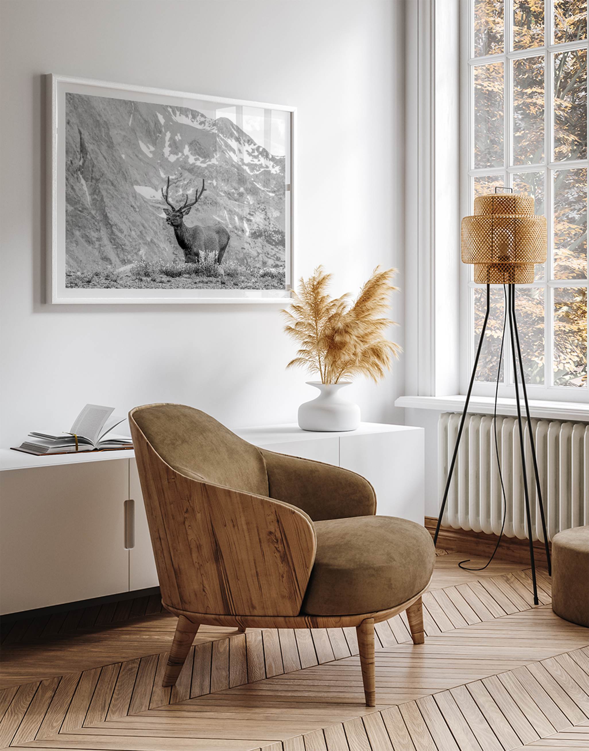 Capture the spirit of Rocky Mountain National Park with this black and white fine art Elk photo print. A majestic Elk stands on top of a bed of flowers with a snow-covered mountain behind it.