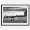 This Utah desert fine art photography print features two horse riders riding toward the horizon of the Utah desert with the unique towering rocks of Monument Valley as the backdrop. The dramatic cloudy sky adds intensity and beauty to the scene.
