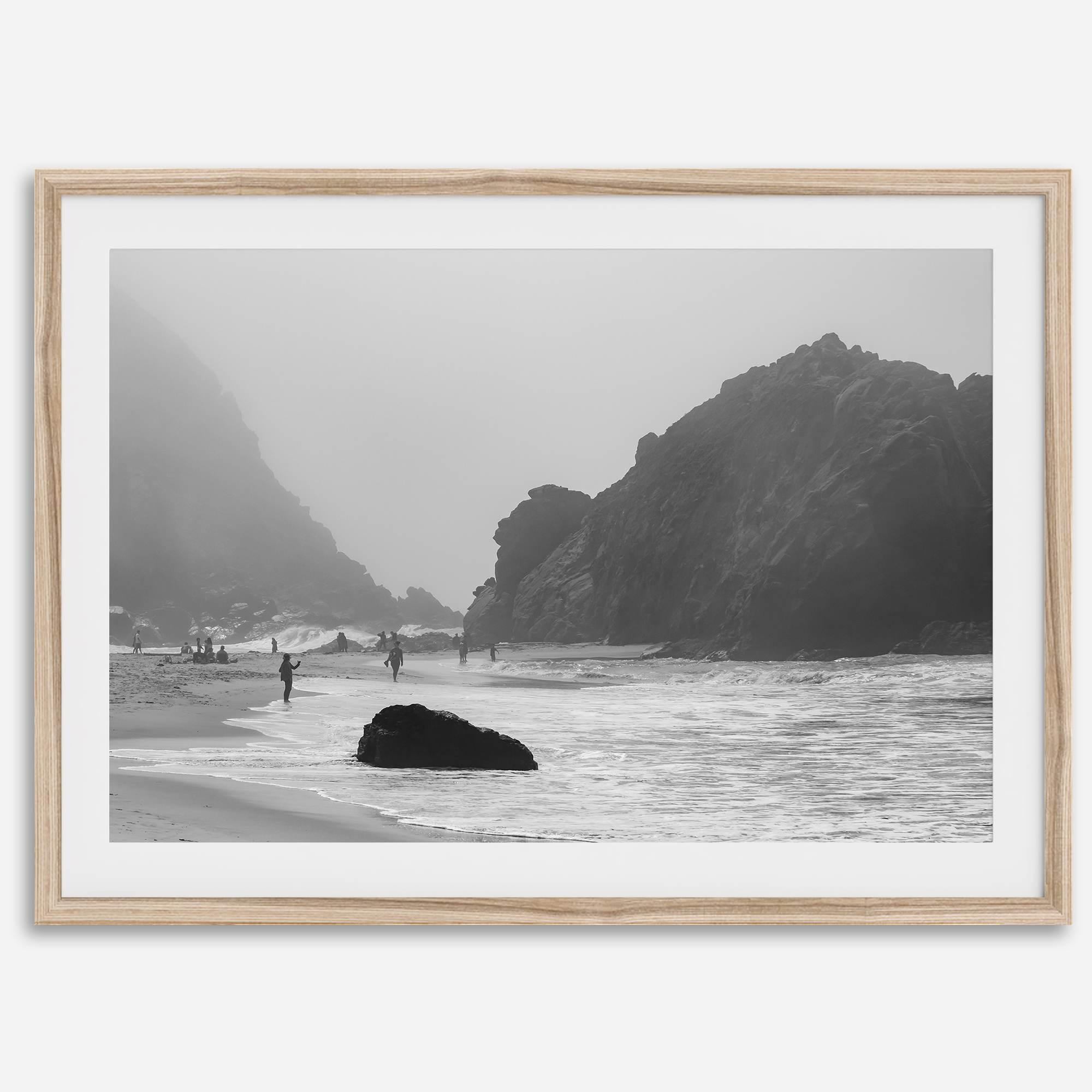 A framed black and white print of the beautiful Pfeiffer Beach in Big Sur hung in the living room. This wall art showcases the dramatic rocks and mist of the Big Sur coastline and the day-to-day life of the beach.