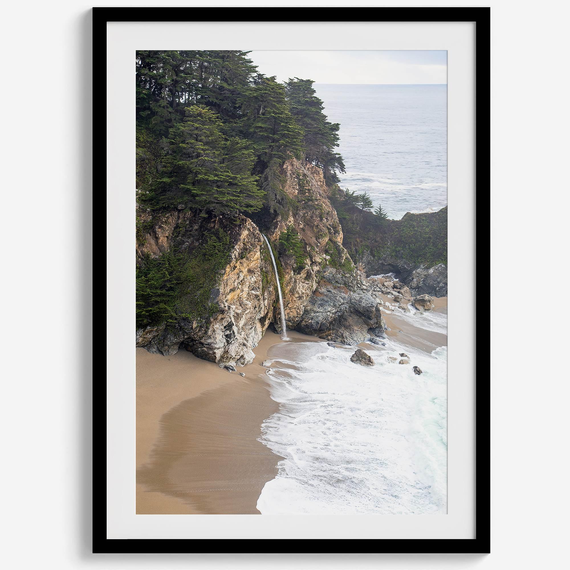 This captivating California coastal beach print captures the awe-inspiring scene of McWay Falls in Big Sur, as its creamy waterfall cascades onto a pristine beach and merges with the rhythmic dance of the ocean waves.