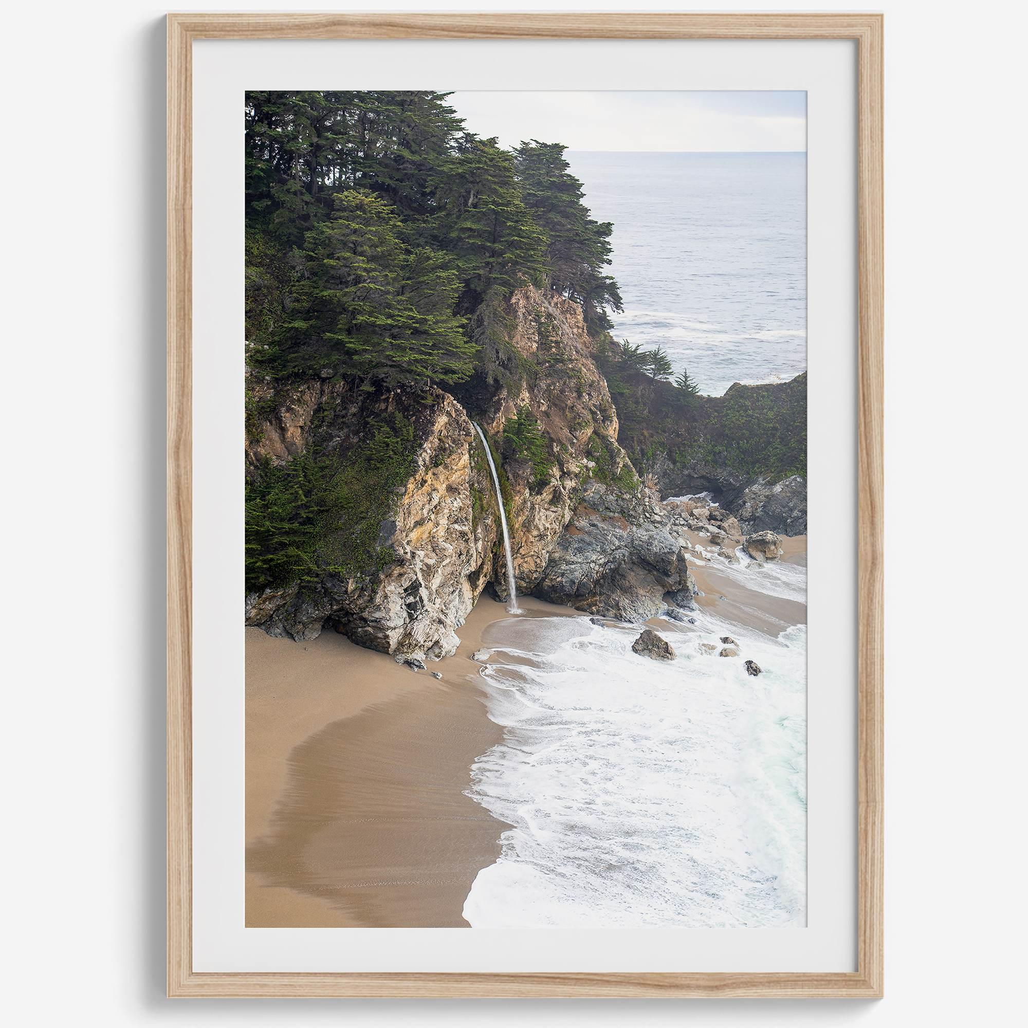 This captivating California coastal beach print captures the awe-inspiring scene of McWay Falls in Big Sur, as its creamy waterfall cascades onto a pristine beach and merges with the rhythmic dance of the ocean waves.