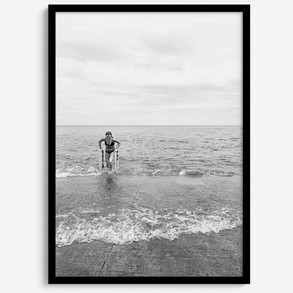A black and white fine art lake beach print of a beach in Chicago on the coast of Lake Michigan showcasing a woman bathing in the lake. The classic modern look of the print is sure to impress when hung on your walls.