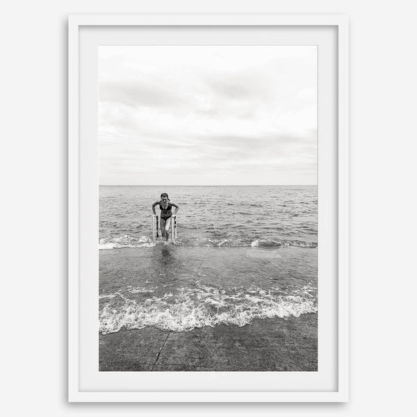 A black and white fine art lake beach print of a beach in Chicago on the coast of Lake Michigan showcasing a woman bathing in the lake. The classic modern look of the print is sure to impress when hung on your walls.
