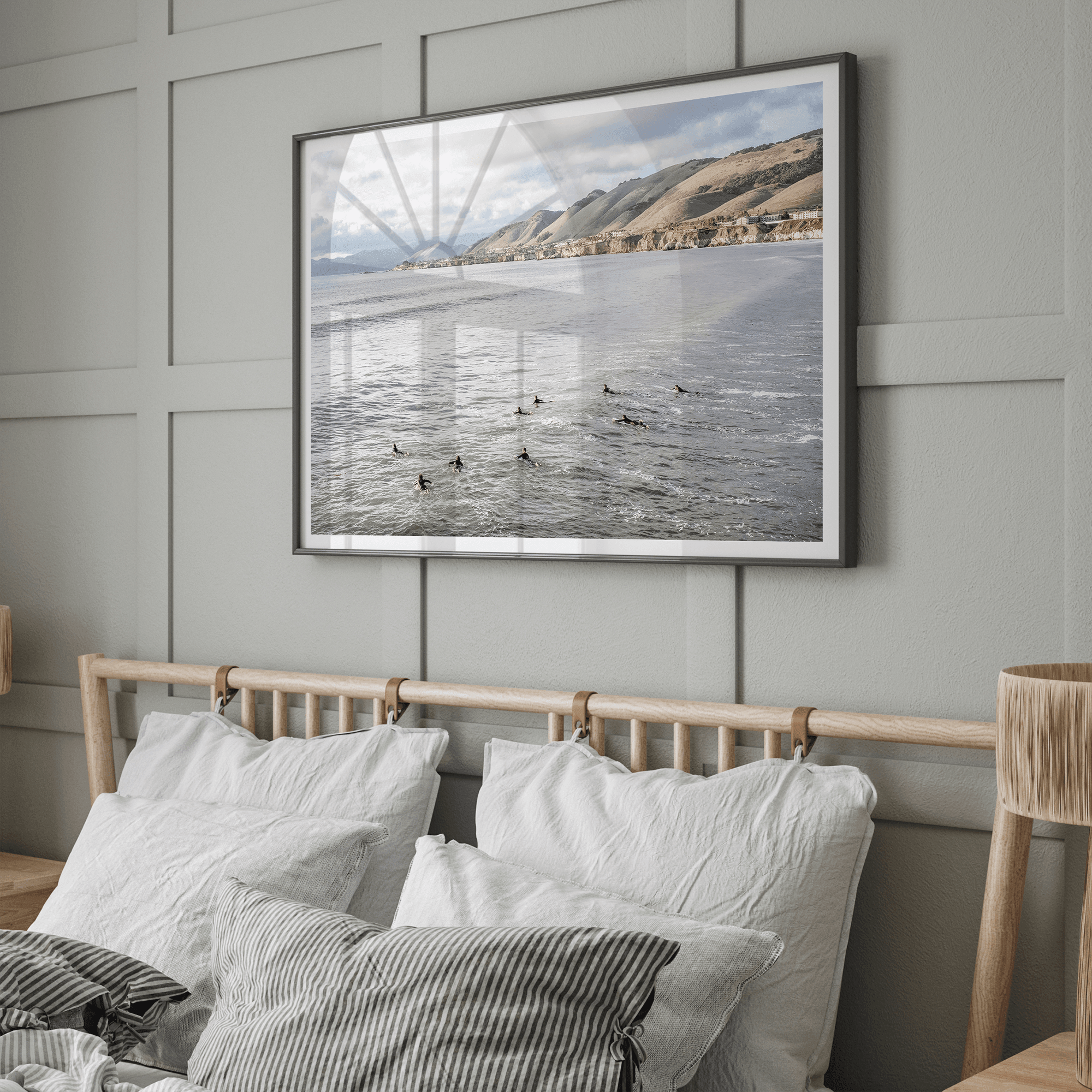 Surfers paddling near Pismo Beach captured in a fine art photography print with coastal cliffs and serene ocean views.