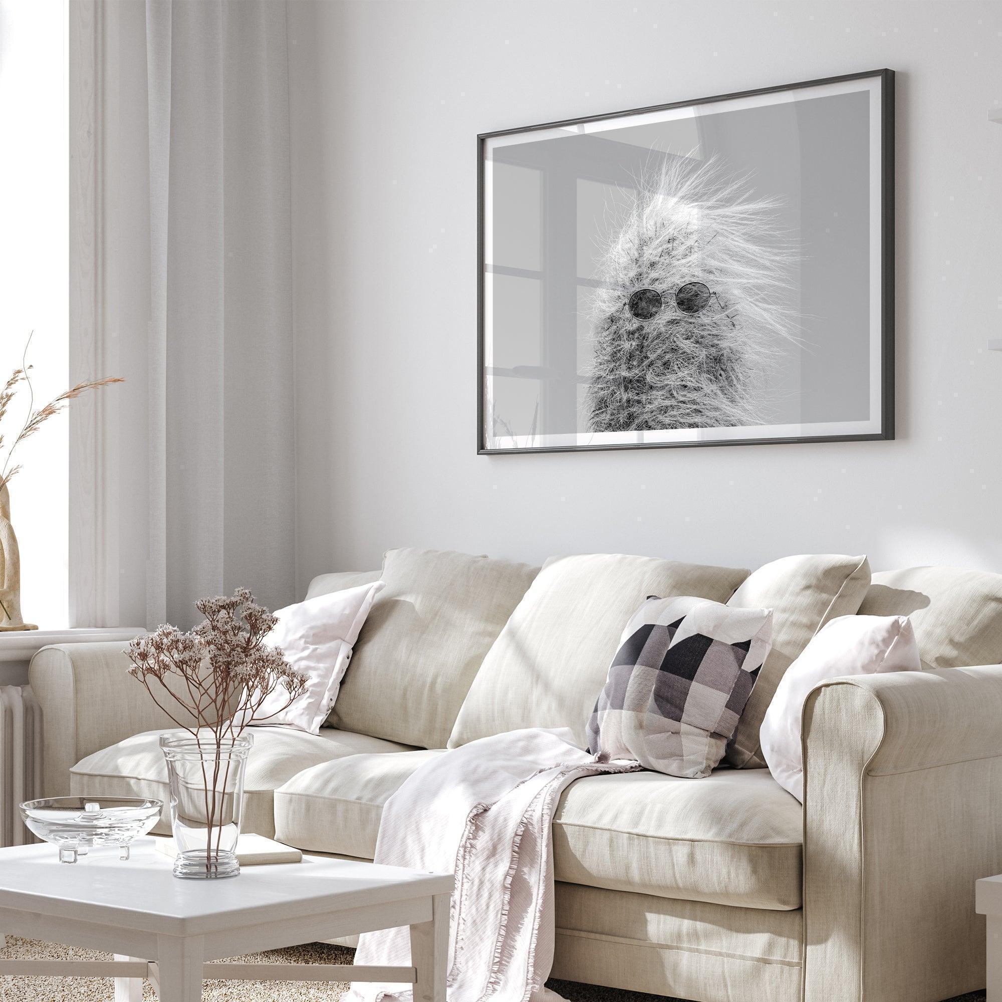 Black-and-white cactus print featuring a windswept cool cactus with sunglasses in a minimalist desert setting.