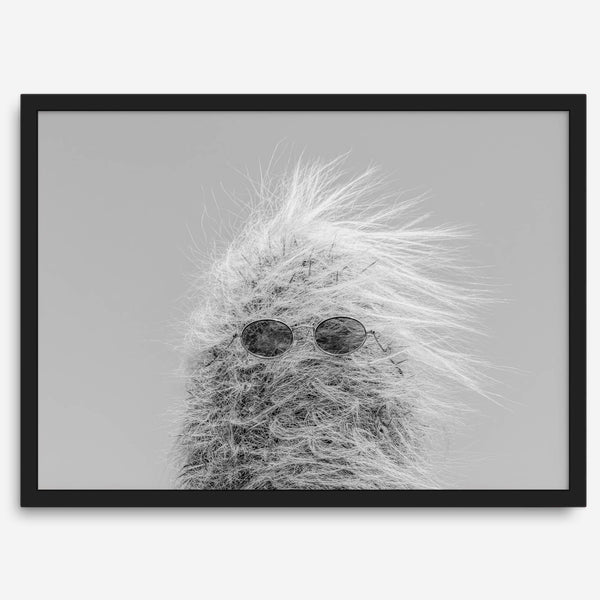 Black-and-white cactus print featuring a windswept cool cactus with sunglasses in a minimalist desert setting.