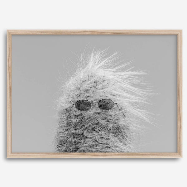 Black-and-white cactus print featuring a windswept cool cactus with sunglasses in a minimalist desert setting.