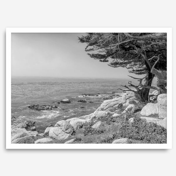 Black and white coastal art featuring Pebble Beach’s rocky shoreline and ocean view.