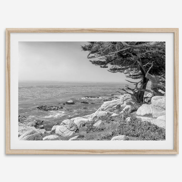 Black and white coastal art featuring Pebble Beach’s rocky shoreline and ocean view.
