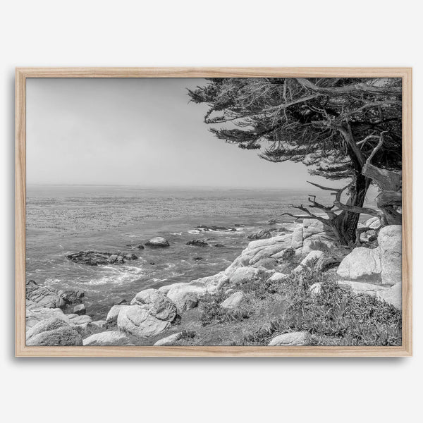 Black and white coastal art featuring Pebble Beach’s rocky shoreline and ocean view.