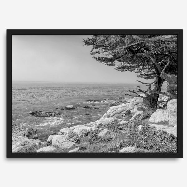 Black and white coastal art featuring Pebble Beach’s rocky shoreline and ocean view.
