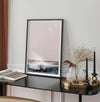 This extraordinary ocean wall art captures a mesmerizing moment when a powerful wave crashes while the sunset gentle blush pink hues fill the sky and a large full moon rises majestically in the backdrop.
