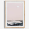 This extraordinary ocean wall art captures a mesmerizing moment when a powerful wave crashes while the sunset gentle blush pink hues fill the sky and a large full moon rises majestically in the backdrop.