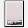 This extraordinary ocean wall art captures a mesmerizing moment when a powerful wave crashes while the sunset gentle blush pink hues fill the sky and a large full moon rises majestically in the backdrop.