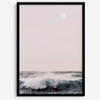 This extraordinary ocean wall art captures a mesmerizing moment when a powerful wave crashes while the sunset gentle blush pink hues fill the sky and a large full moon rises majestically in the backdrop.