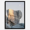Minimalist desert moon wall art featuring massive sunlit rock formations beneath a pale moon and soft gray sky. Southwest fine art photography.