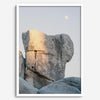 Minimalist desert moon wall art featuring massive sunlit rock formations beneath a pale moon and soft gray sky. Southwest fine art photography.