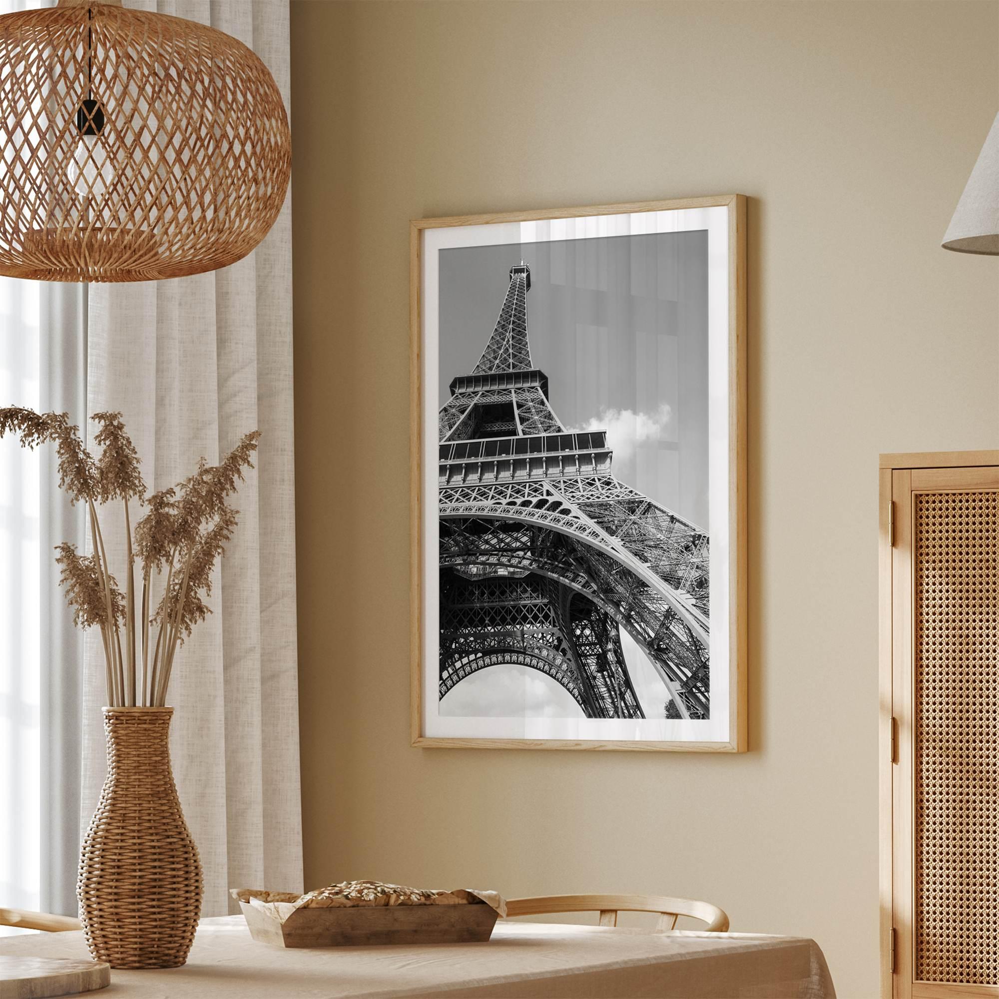 A fine art Eiffel Tower black and white print. This Paris theme wall art showcases a unique wide-angle view from the bottom of the tower, creating a modern, trendy fine art photography to hang on your walls.