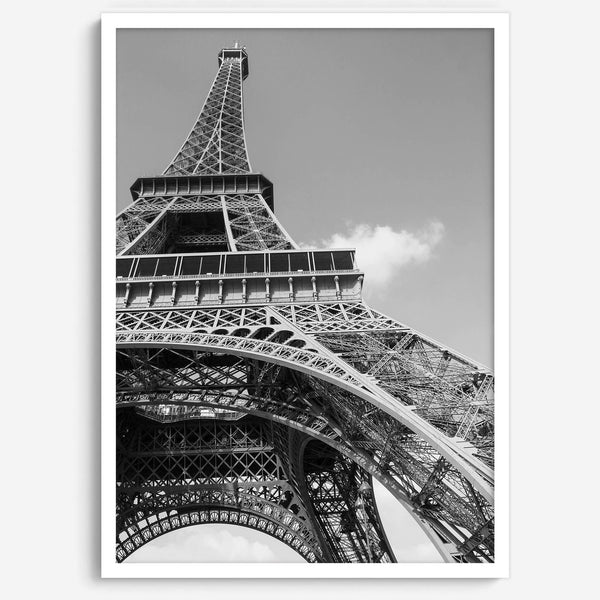 A fine art Eiffel Tower black and white print. This Paris theme wall art showcases a unique wide-angle view from the bottom of the tower, creating a modern, trendy fine art photography to hang on your walls.