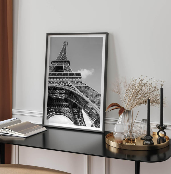 A fine art Eiffel Tower black and white print. This Paris theme wall art showcases a unique wide-angle view from the bottom of the tower, creating a modern, trendy fine art photography to hang on your walls.