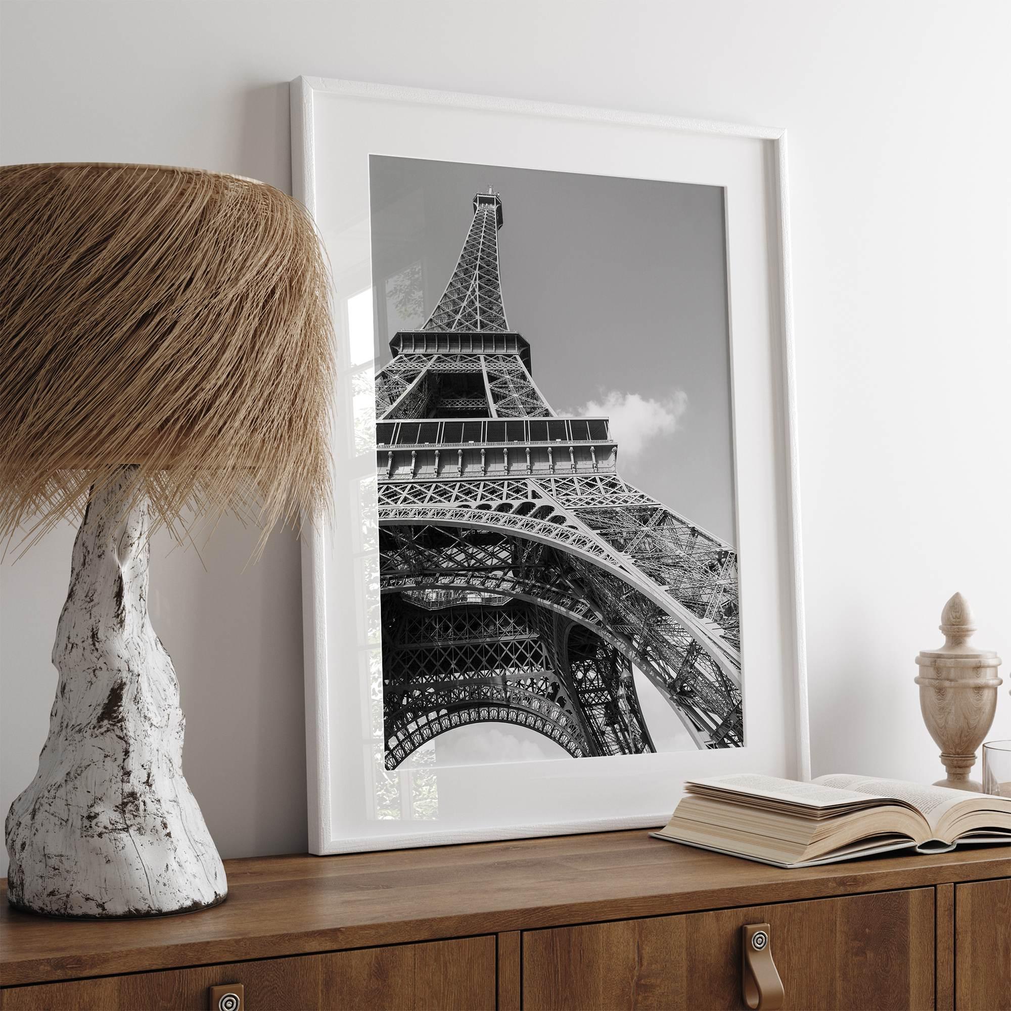 A fine art Eiffel Tower black and white print. This Paris theme wall art showcases a unique wide-angle view from the bottom of the tower, creating a modern, trendy fine art photography to hang on your walls.