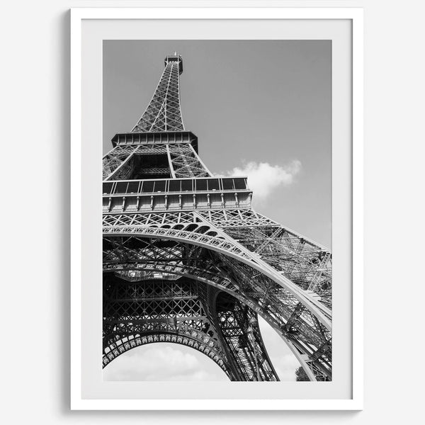 A fine art Eiffel Tower black and white print. This Paris theme wall art showcases a unique wide-angle view from the bottom of the tower, creating a modern, trendy fine art photography to hang on your walls.