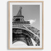 A fine art Eiffel Tower black and white print. This Paris theme wall art showcases a unique wide-angle view from the bottom of the tower, creating a modern, trendy fine art photography to hang on your walls.