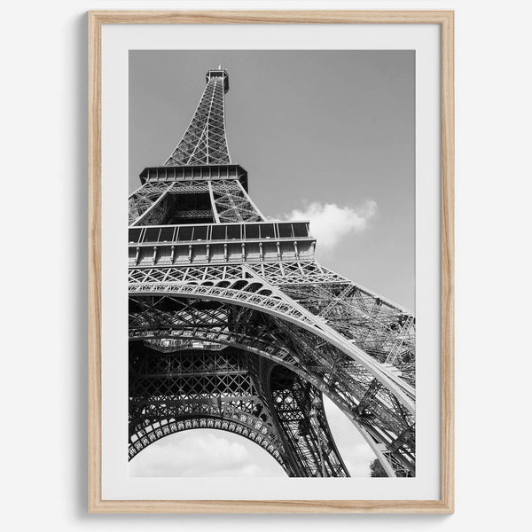 A fine art Eiffel Tower black and white print. This Paris theme wall art showcases a unique wide-angle view from the bottom of the tower, creating a modern, trendy fine art photography to hang on your walls.
