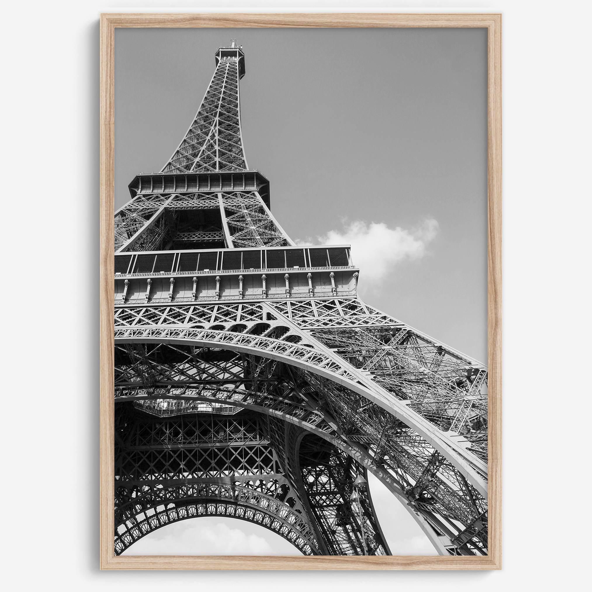 A fine art Eiffel Tower black and white print. This Paris theme wall art showcases a unique wide-angle view from the bottom of the tower, creating a modern, trendy fine art photography to hang on your walls.