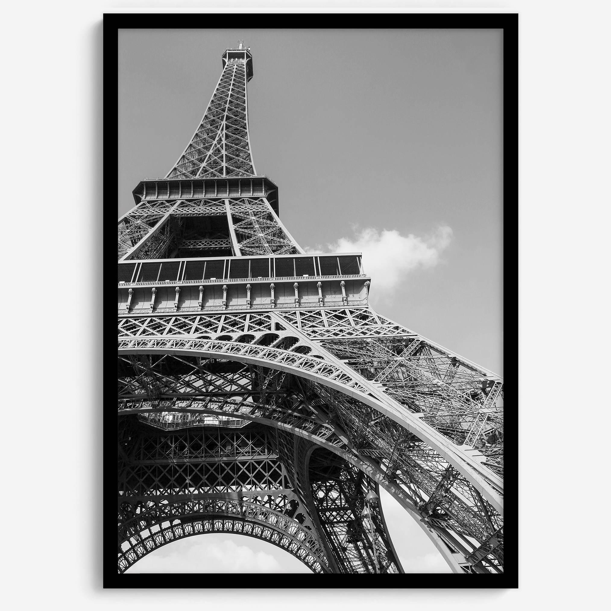 A fine art Eiffel Tower black and white print. This Paris theme wall art showcases a unique wide-angle view from the bottom of the tower, creating a modern, trendy fine art photography to hang on your walls.