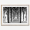 A large fine art abstract black and white beach pier print This stunning beach wall art shows the symmetric structure of the pier with the ocean water gently caressing the pier and beach.