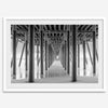 A large fine art abstract black and white beach pier print This stunning beach wall art shows the symmetric structure of the pier with the ocean water gently caressing the pier and beach.
