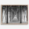 A large fine art abstract black and white beach pier print This stunning beach wall art shows the symmetric structure of the pier with the ocean water gently caressing the pier and beach.