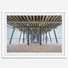 A fine art boho style beach photography print featuring a view from below Pismo Beach Pier.
