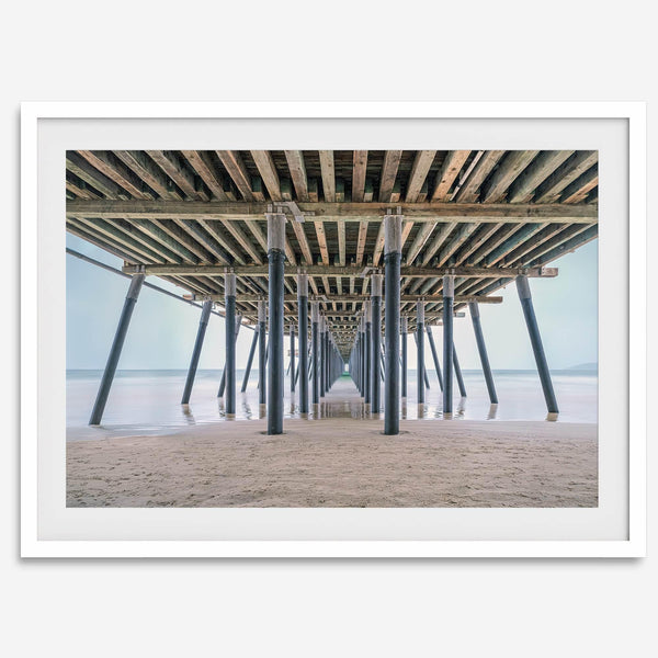 A fine art boho style beach photography print featuring a view from below Pismo Beach Pier.