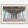 A fine art boho style beach photography print featuring a view from below Pismo Beach Pier.