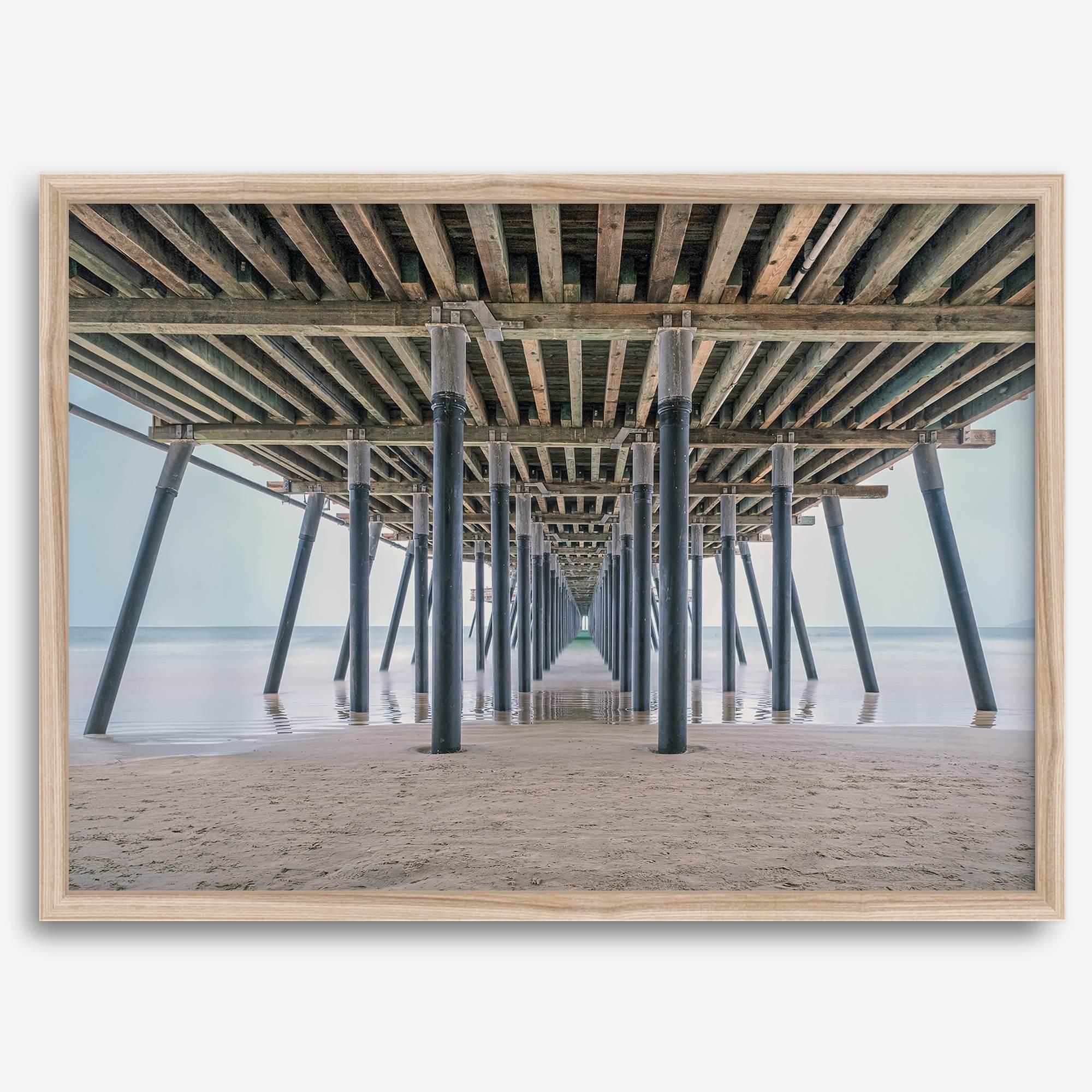 A fine art boho style beach photography print featuring a view from below Pismo Beach Pier.