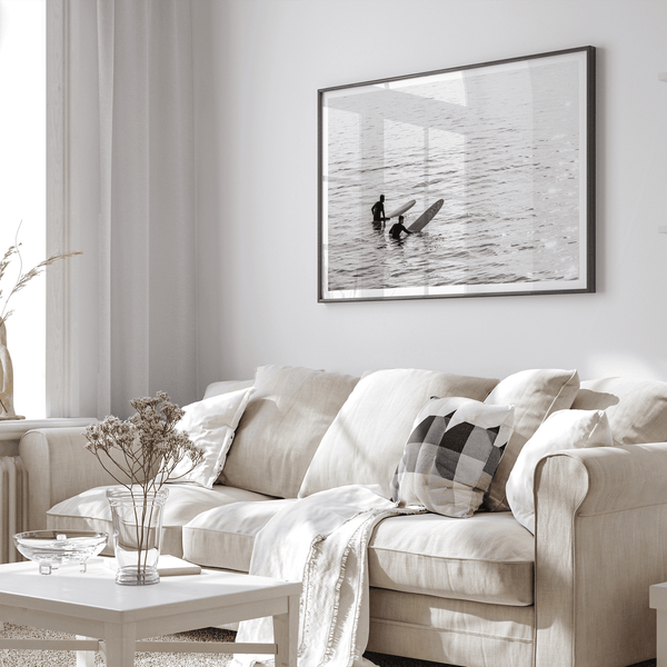 Black and white photo of two surfers with longboards waiting in calm ocean water – fine art surf photography print