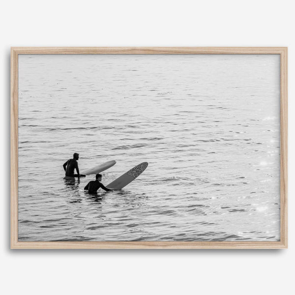 Black and white photo of two surfers with longboards waiting in calm ocean water – fine art surf photography print
