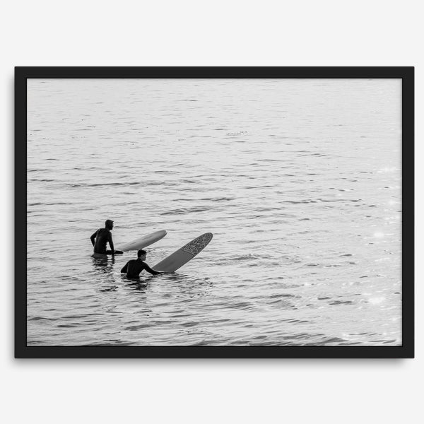 Black and white photo of two surfers with longboards waiting in calm ocean water – fine art surf photography print