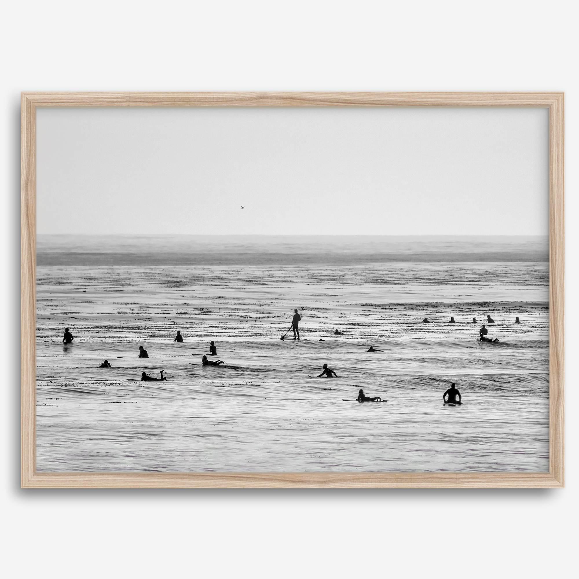 Black and white surf prints showing surfers in calm ocean waters, perfect for beach house wall art or minimalist coastal decor.