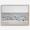Black and white surf prints showing surfers in calm ocean waters, perfect for beach house wall art or minimalist coastal decor.