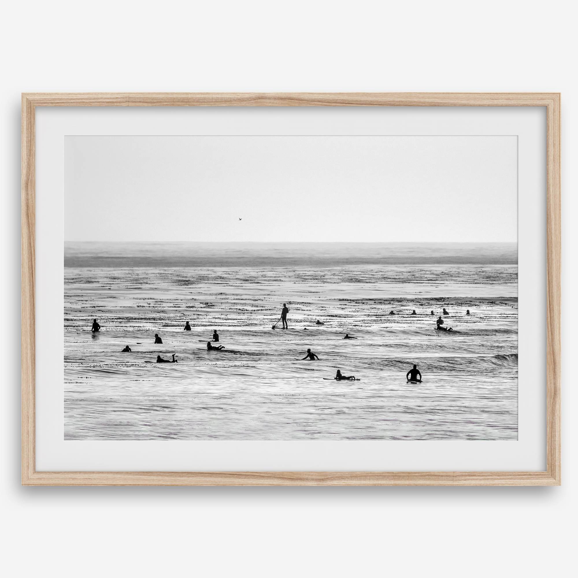 Black and white surf prints showing surfers in calm ocean waters, perfect for beach house wall art or minimalist coastal decor.