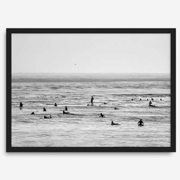 Black and white surf prints showing surfers in calm ocean waters, perfect for beach house wall art or minimalist coastal decor.