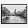 Black and white photo of Lincoln Park, Chicago. A lone rower glides on the park canal with the iconic Willis Tower (formerly Sears Tower) and Chicago skyline in the background.