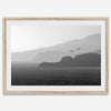A black and white coastal wall art that showcases two Pelicans flying over the Pacific Ocean near the Golden Gate Bridge toward the layered mountains in the sunset.