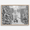 A fine art black and white mountain ski print showing a ski lift winding up the mountain with a stunning winter snow forest around it.
