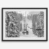 A fine art black and white mountain ski print showing a ski lift winding up the mountain with a stunning winter snow forest around it.